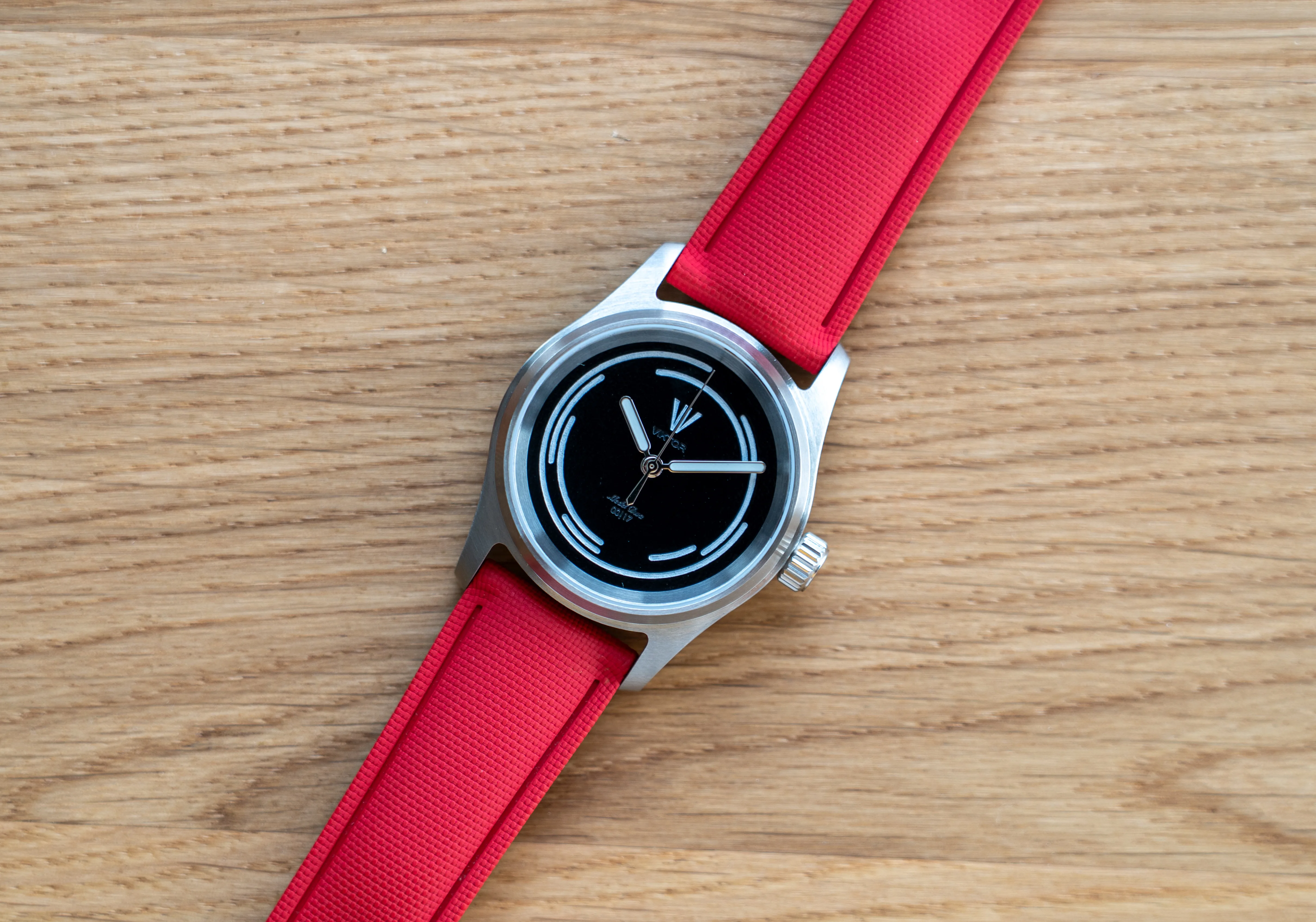 Model Dwa on a red rubber strap